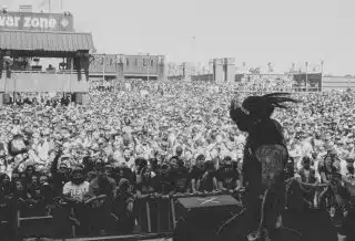 grayscale photo of people on a concert