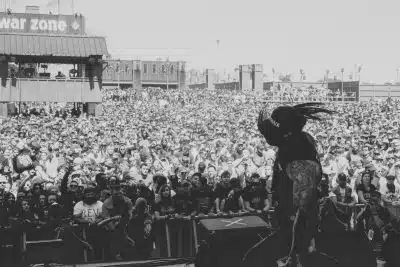 grayscale photo of people on a concert